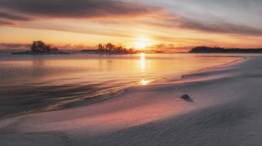 Winter sunrise on Lake Ladoga in Karelia, Russia clipart