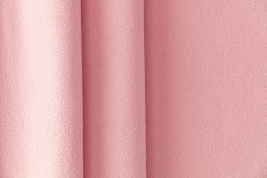 Açık pembe yün yüzeyi, kıvrımlarla örtülmüş, arka plan