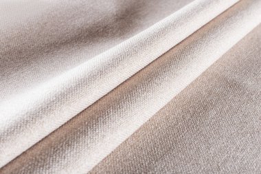 krem rengi yoğun döşeme kumaşı keten desenli, katlanmış kumaş.