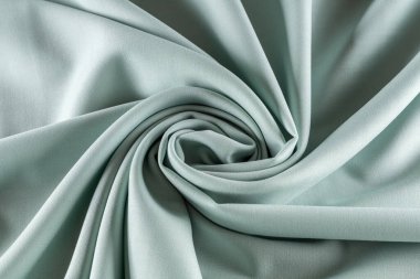 Terzilik için gümüş kumaş spiral ve arka planda