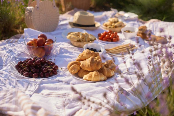 summer picnic in lavender fields. still life summer outdoor picnic with bread and berries
