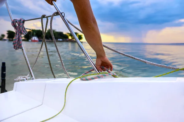 man working on sailboat, sailor enjoys yachting sport activities, sailing the oceans. shallow depth of field photo