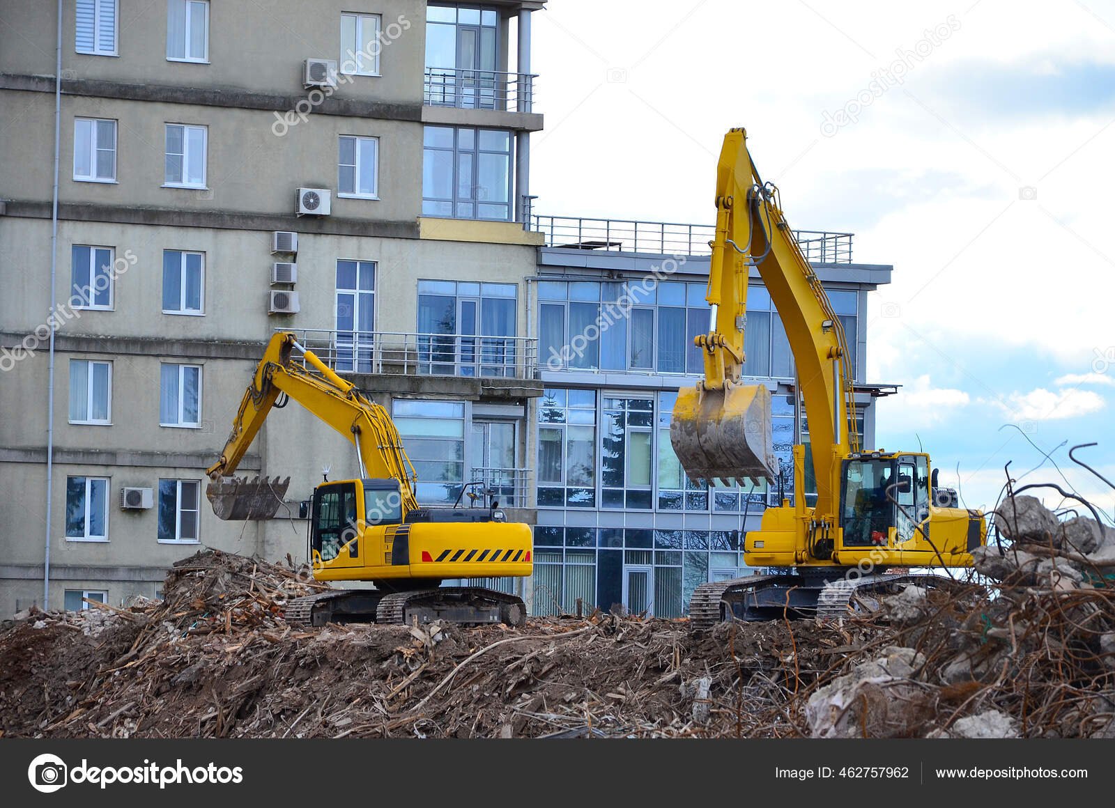 Building destruction, demolition of a building by an yellow excavators