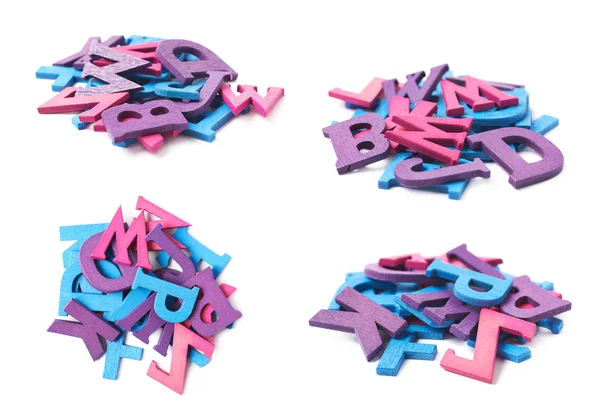 Pile of colorful wooden letters isolated — Stock Photo, Image