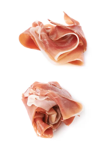 Folded prosciutto ham slice isolated — Stock Photo, Image