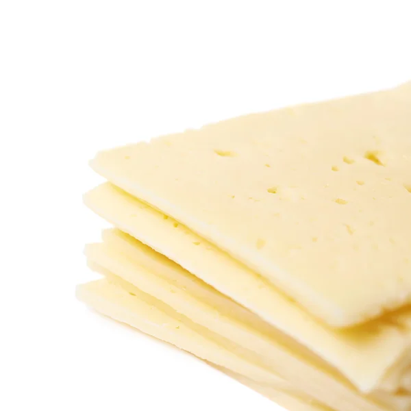 分離されたチーズのスライスの山 — ストック写真