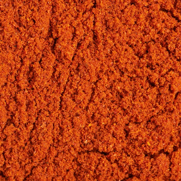 Surface covered with paprika powder — Stock Photo, Image