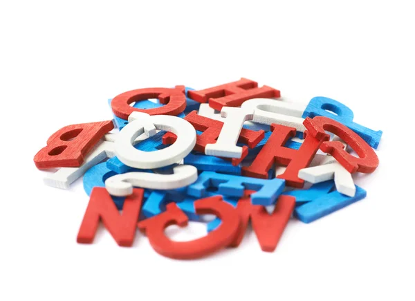 Pile of painted wooden letters isolated — Stock Photo, Image