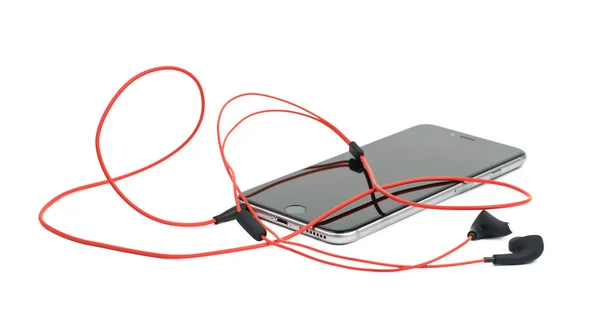 Rote Kopfhörer im Smartphone isoliert — Stockfoto