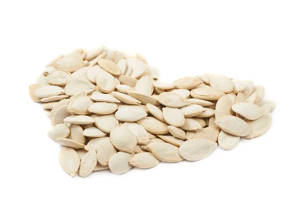 Heart shape made of pumpkin seeds isolated — Stock Photo, Image