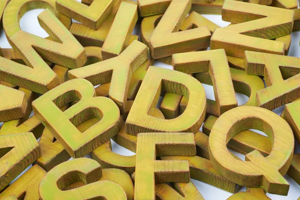 Surface coated with multiple wooden letters — Stock Photo, Image