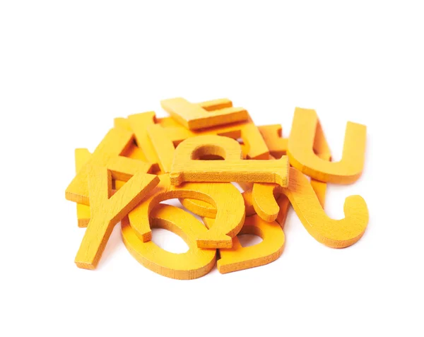 Pile of painted wooden letters isolated — Stock Photo, Image