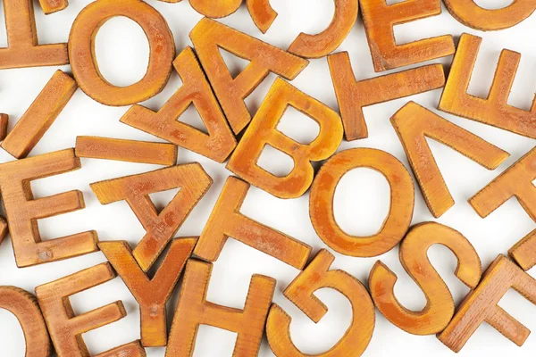 Surface coated with multiple wooden letters — Stock Photo, Image