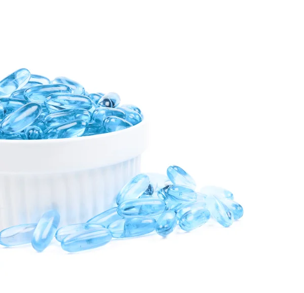 Skål full av blå softgel tabletter — Stockfoto