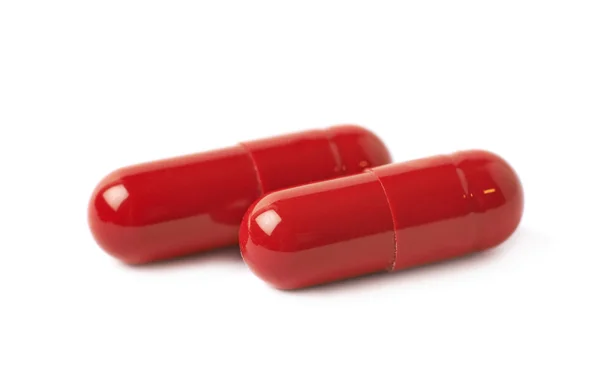 Duas pílulas vermelhas isoladas — Fotografia de Stock