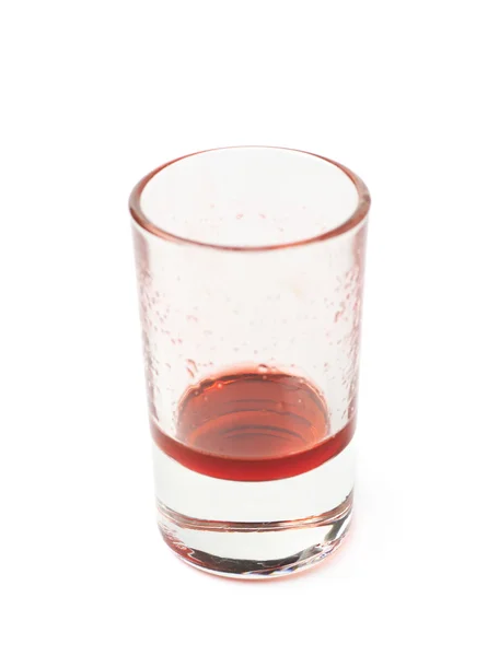 Glass shot with grenadine leftovers — Stock Photo, Image