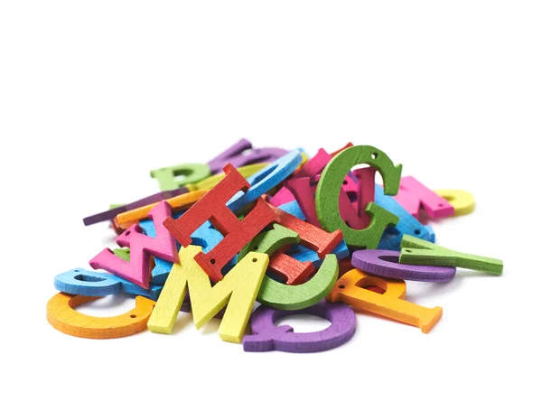 Pile of colorful wooden letters isolated — Stock Photo, Image