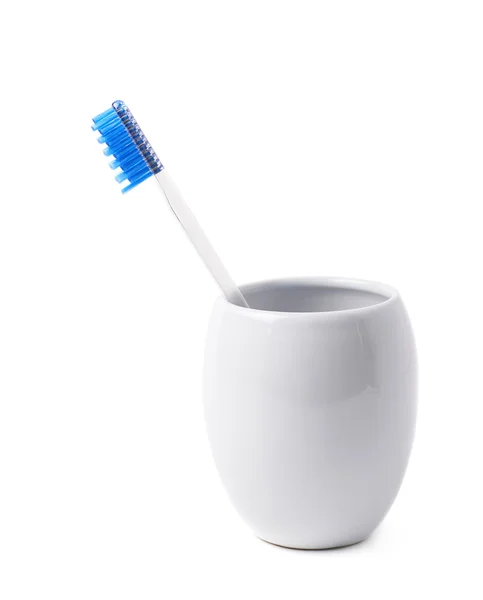 Blue toothbrush in a cup isolated — Stock Photo, Image