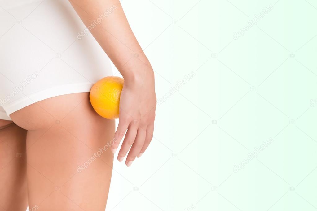 Woman Holding an Orange Against Her Thighs