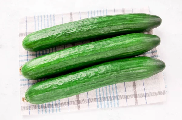 Three Cucumbers Kitchen Towel White Background Salad Spring Green Vegetables — Foto de Stock