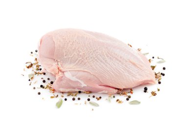 Beyaz arka planda baharatlı çiğ hindi filetosu. Pişmemiş hindi eti nugget ya da escalope için..