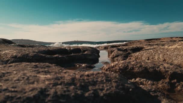 Tropical rocky beach. Sea waves washing on the rocky shore with salt pools . Low angle shot — Stock Video