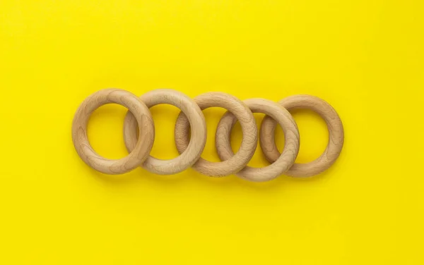 Five Wooden Rings Yellow Background Natural Wood Baby Teether Eco — Stock Photo, Image