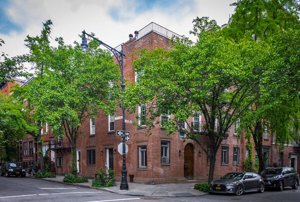 New York City, USA, May 2019, view of a red brick building at Waverly Place and W 11 St in the West Village neighborhood