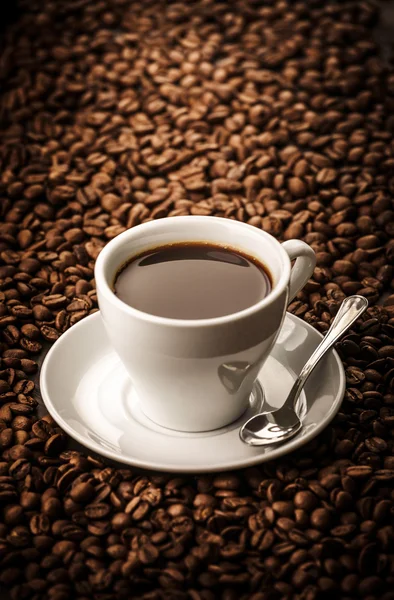 Black coffee on beans background — Stock Photo, Image