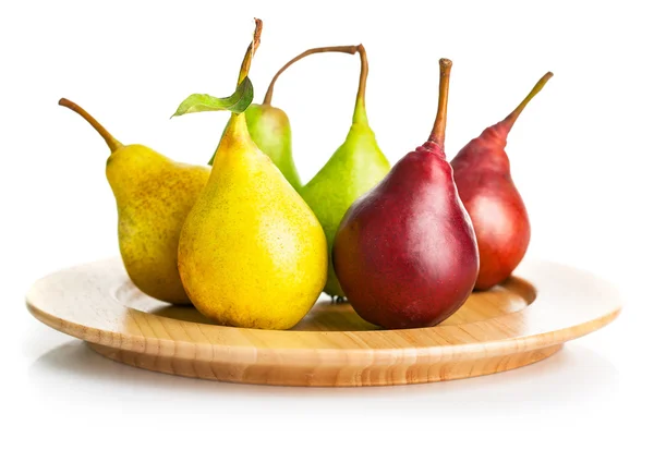 Fresh pears on the wooden plate — Stock Photo, Image
