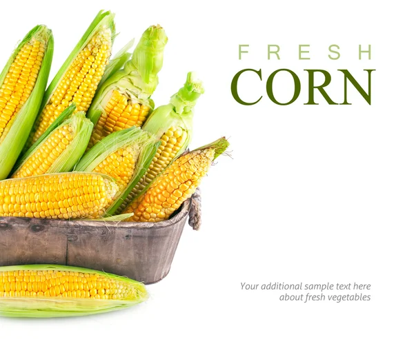 Fresh corn with green leaf in wooden basket — Stock Photo, Image