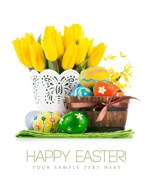 Easter eggs in basket with yellow tulips — Stock Photo, Image