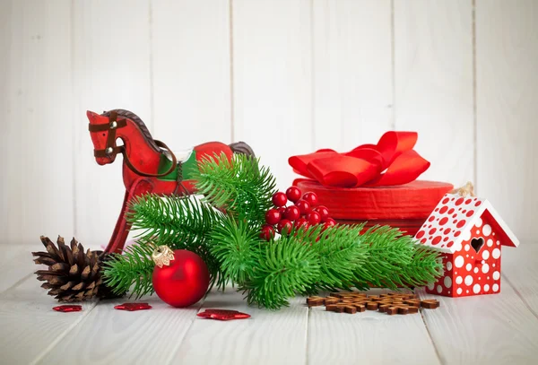 Christmas balls with branch fir and pinecone on wooden board — Stock Photo, Image