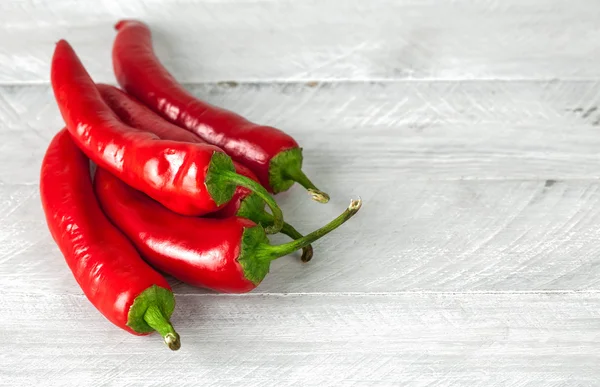 Pepper chili on grey wooden board — Stock Photo, Image