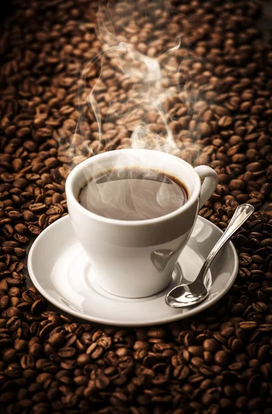Hot coffee with beans background — Stock Photo, Image