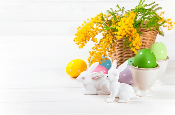 Easter eggs with rabbit and branch mimosa — Stock Photo, Image