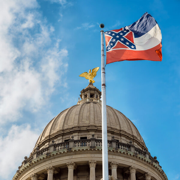 Mississippi state flag flying in front of capitol building in Ja