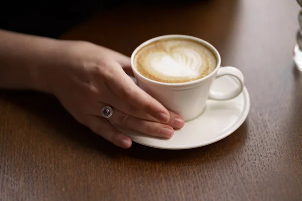 Bliżej kobieta ręka trzyma filiżankę kawy — Zdjęcie stockowe