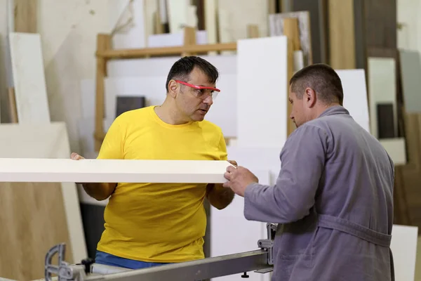 Twee timmerlieden werken met hout in de werkplaats — Stockfoto