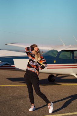 Spor kıyafetli ve güneş gözlüklü bir model.