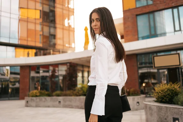 Mulher bonita em camisa branca em prédios de negócios fundo — Fotografia de Stock