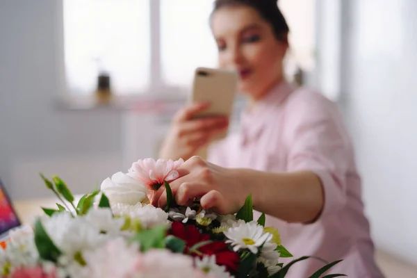 Mujer tomando foto composición de flores en el teléfono inteligente —  Fotos de Stock