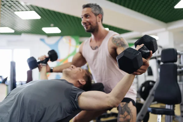 Jovem tem treino com personal trainer no ginásio — Fotografia de Stock