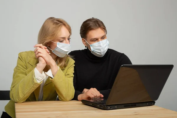 Young Beautiful Couple Man Woman Sitting Table Laptop Protective Masks Royalty Free Stock Images