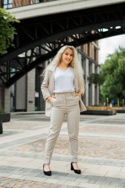 Şehirde yaz elbisesi içinde güzel genç bir kadın.