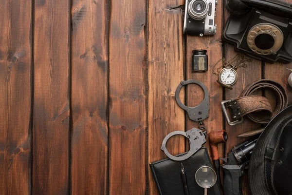 Detective agent equipment on the desk flat lay concept background.