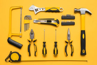 Sarı düz zemin üzerinde inşaat araçları uzanır.