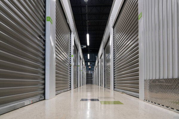 Storage warehouse interior. Metal garage doors with locks. Low angle view