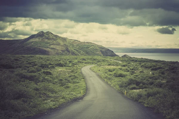 Curved asphalt road in high mountains of Iceland — Stock Photo, Image