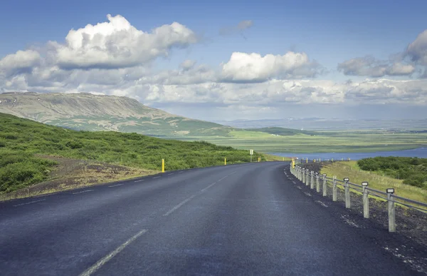 Estrada de asfalto curvada em altas montanhas da Islândia — Fotografia de Stock